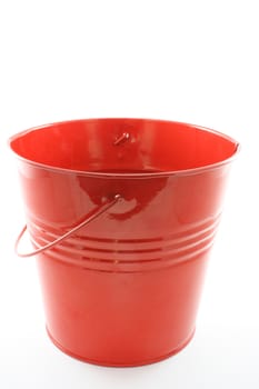 A red tin bucket isolated on white.