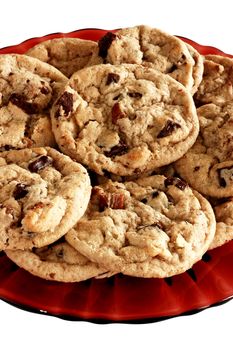 Chocolate chip cookies on a red plate.