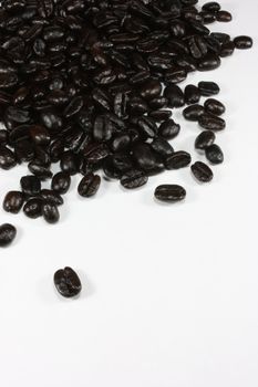 Dark roast fair trade organic coffee beans, isolated on white.