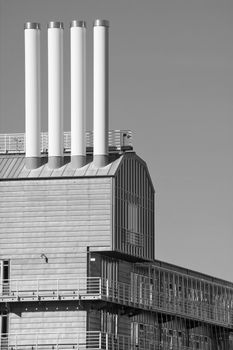 Four chimneys on the roof of a modern corporate building, which is supposed to look like a ship, being located in the harbour of Hamburg/Germany.
