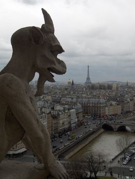 A gargoyle's view of Paris, including the Seine River and the Efiiel Tower, taken from atop the Notre Dame Cathedral.