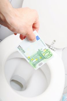 money and toilet showing financial crisis concept