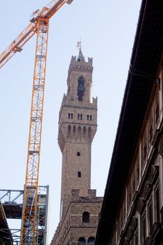 Palazzo Vecchio and a yellow crane 
