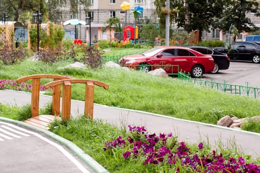 A small wooden bridge in a city yard 
