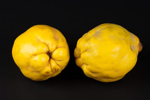 Fresh quince fruit isolated on black background