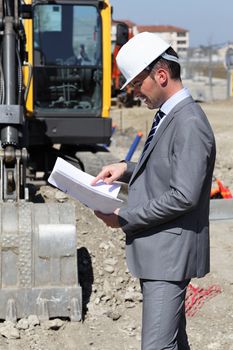 young man with hardhat on building site