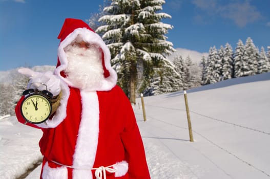 Santa Claus, Father Christmas holds watch clock