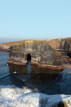 snow covered view of cliffs and the virgin rock in ballybunion county kerry ireland