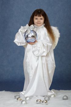 Girl holding a New Year's ball on a blue background