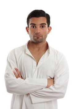 A casual ethnic man with arms crossed and looking ahead.  White background.