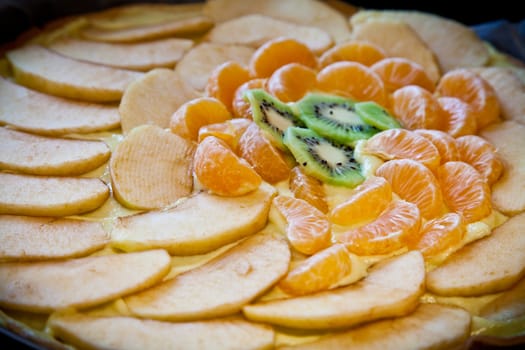 Fresh ingredients ready for a fruit cake: kiwi, apple and mandarin