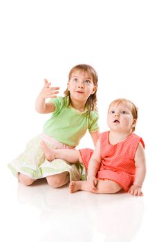 Two little Sisters looking up with interest isolated on white