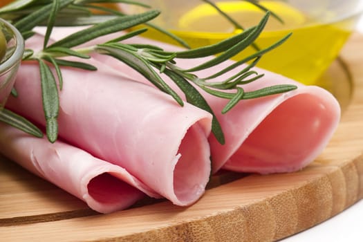 Rolled slices of ham, olive oil and rosemary 