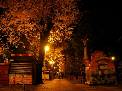 Autumn; park; square; a roadway; a tile; night; lanterns; leaves; illumination