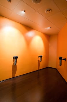 Modern smoking room with orange walls and brown floor