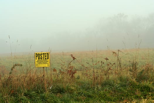 Foggy sign on the edge of a field