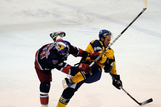 ZELL AM SEE, AUSTRIA - DECEMBER 7: Austrian National League. Hard hit by Jakub Nakovsky. Game EK Zell am See vs. Red Bulls Salzburg (Result 4-6) on December 7, 2010, at hockey rink of Zell am See