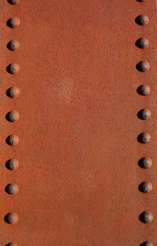 A Rusty metal plate with rivets