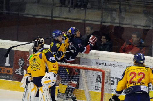 ZELL AM SEE, AUSTRIA - DECEMBER 7: Austrian National League. Hard hit on Salzburgs Unterweger. Game EK Zell am See vs. Red Bulls Salzburg (Result 4-6) on December 7, 2010, at hockey rink of Zell am See