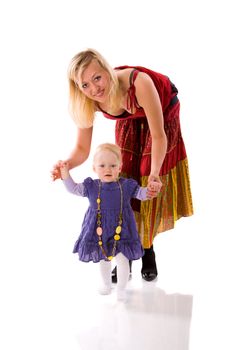 Mother and daughter enjoying First steps isolated on white