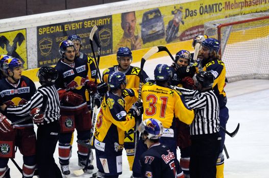 ZELL AM SEE, AUSTRIA - DECEMBER 7: Austrian National League. Marc Brown trying to fight Salzburg player. Game EK Zell am See vs. Red Bulls Salzburg (Result 4-6) on December 7, 2010, at hockey rink of Zell am See