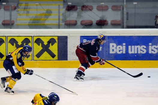 ZELL AM SEE, AUSTRIA - DECEMBER 7: Austrian National League. Salzburg rushes to attacking zone. Game EK Zell am See vs. Red Bulls Salzburg (Result 4-6) on December 7, 2010, at hockey rink of Zell am See