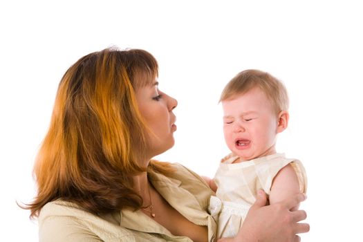 Mother holding crying baby one year age isolated on white