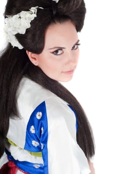 Portrait of the girl of the Asian appearance with a make-up under the geisha on a white background