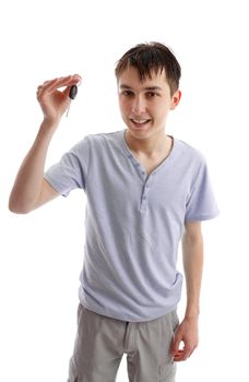 A male teenager holding a car key in one hand. White background.l