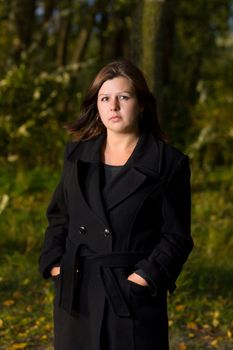 One Woman outdoors wearing black coat autumn park