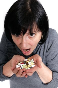 Aged woman holding a pile of pills and capsules in her hands