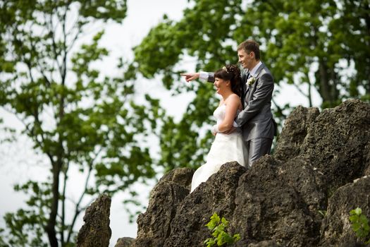 Bride and groom posing summer park outdoors