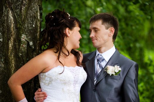 Bride and groom posing summer park outdoors