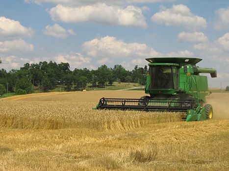 A photograph of a combine harvesting crops.