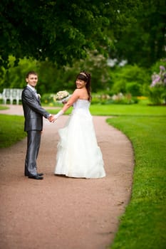 Bride and groom posing summer park outdoors