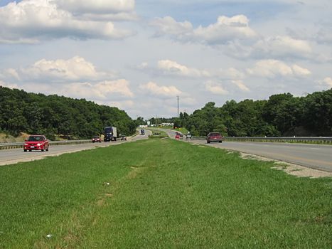 A photograph of automobiles traveling on a road.