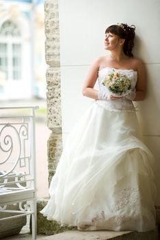 Happy Bride smiling near summer tree outdoors 