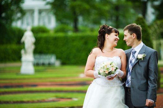 Bride and groom posing summer park outdoors