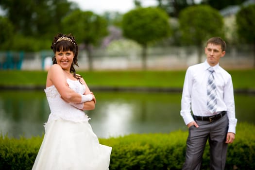 Bride and groom posing summer park outdoors