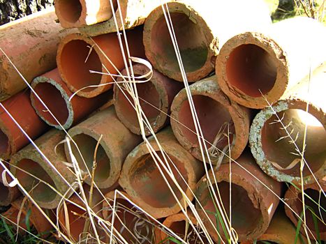 A photograph of clay pipes detailing their shapes and texture.