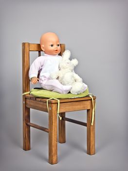 An image of a baby puppet on a chair