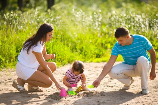 Happy Family playing with kid together summer outdoors