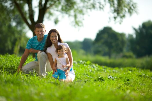 Happy Family posing together summer outdoors 