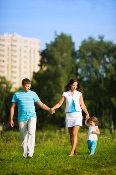 Happy Family walking in front of house outdoors 