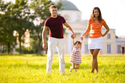 Happy Family in front of house outdoors 