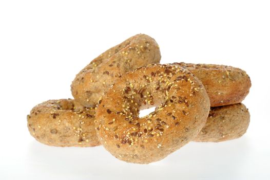 Delicious multigrain bagel shot on a white background.