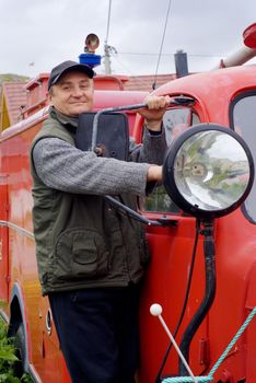 The man by an ancient fire-engine with a lantern