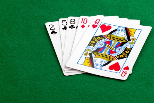 High card poker hand on green background