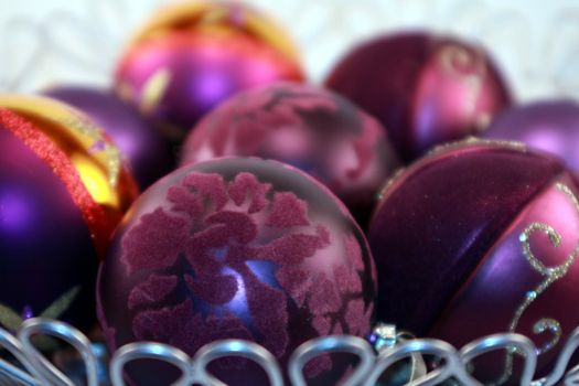 Colorful purple metallic Christmas ornaments for the holidays. Christmas tree decorations for the season.