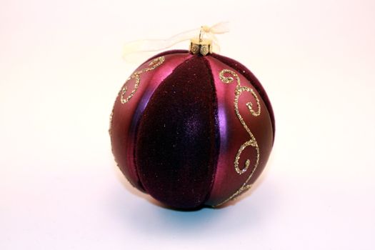 Colorful purple metallic Christmas ornaments for the holidays. Christmas tree decorations for the season.